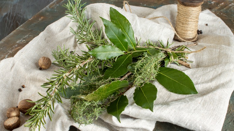 A bouquet garni of culinary herbs with twine on a cheesecloth