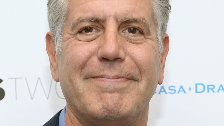 Anthony Bourdain poses at event 