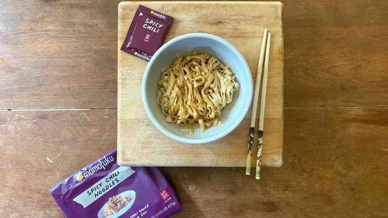 spicy chili sauce packet witha bowl of noodles