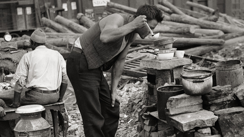 Depression-era hobo jungle community preparing a Mulligan stew