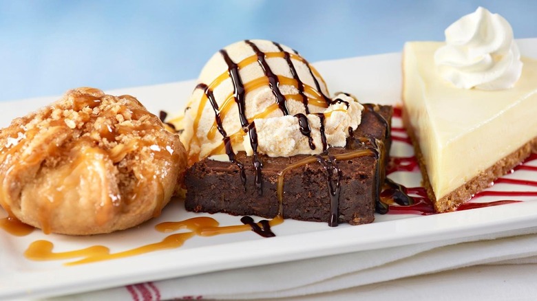 a selection of Red Lobster desserts on a white plate including Key Lime Pie, Apple Crostada, and a Chocolate Brownie à la Mode