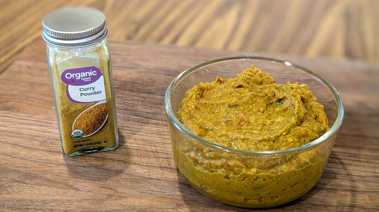 curry powder next to a bowl of curry paste