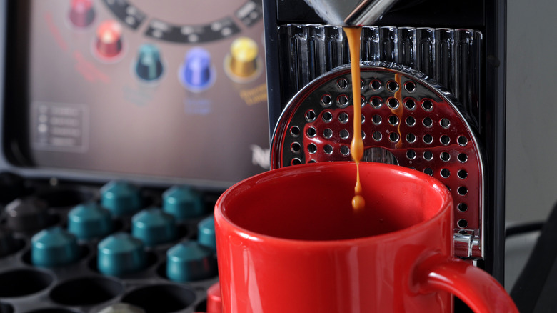 A closeup of coffee brewing through a Nespresso machine