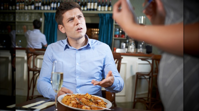 Restaurant patron complaining to server