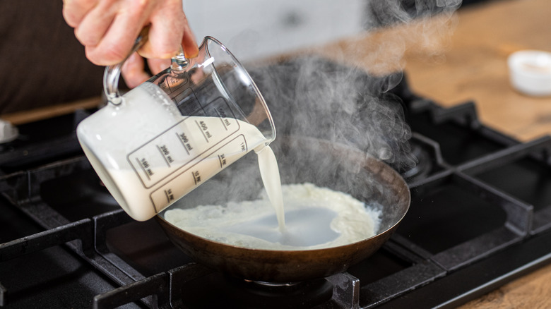pouring milk into hot pan