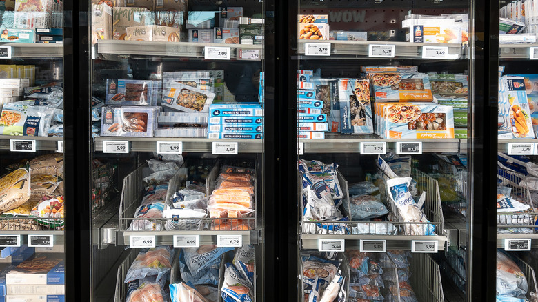 Frozen seafood products inside freezers in Aldi store, including shellfish and battered fish filets