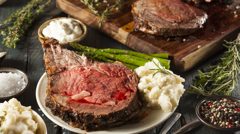 slice of prime rib with mashed potatoes and asparagus