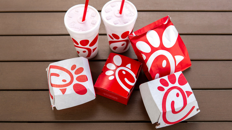 Boxes of Chick-fil-A and drinks on a wooden table