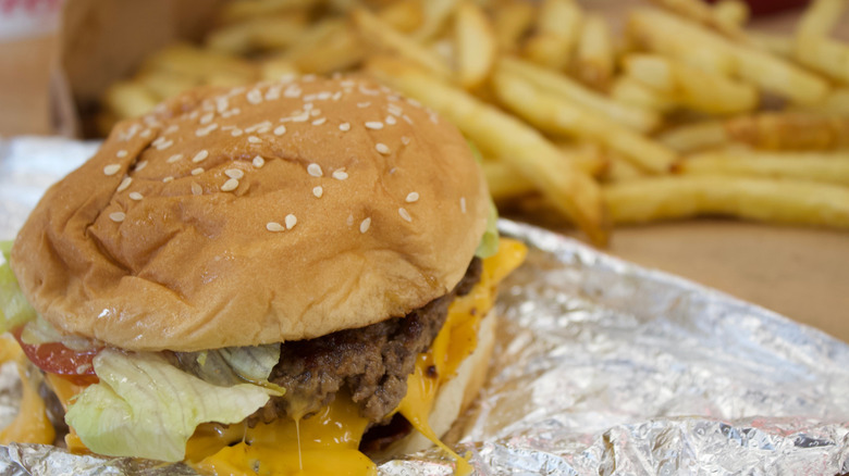 Melting burger from Five Guys with fries in the background