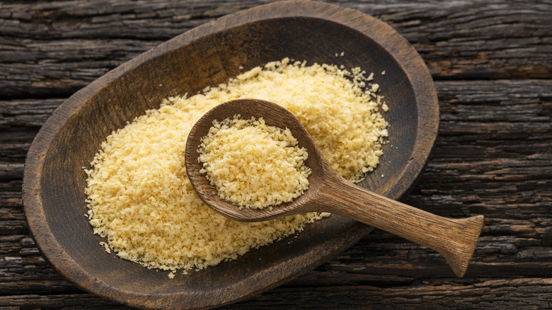 a wooden bowl of panko breadcrumbs with a wooden spoon in it