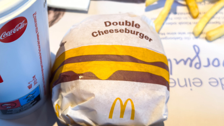 McDonald's Double Cheeseburger in a paper wrapper