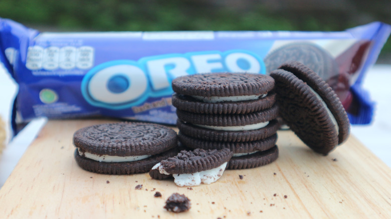 Classic Oreo cookies stacked on a cutting board