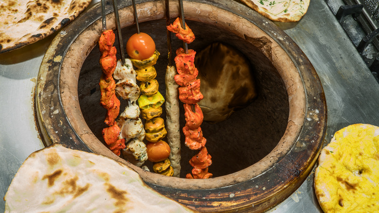 food cooking inside tandoor oven