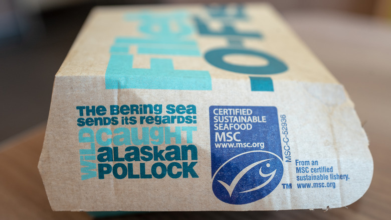 A close-up of a McDonald's Filet-O-Fish package stating it is made with wild-caught Alaskan pollock