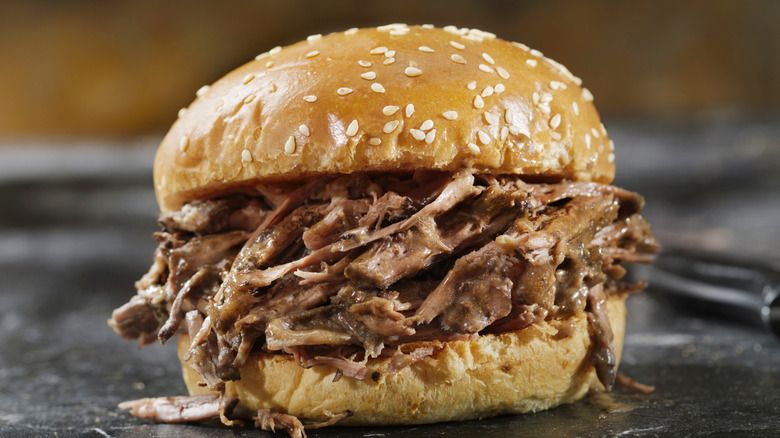 Closeup of a roast beef sandwich on a sesame bun
