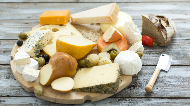 A platter of assorted cheeses on a wooden table