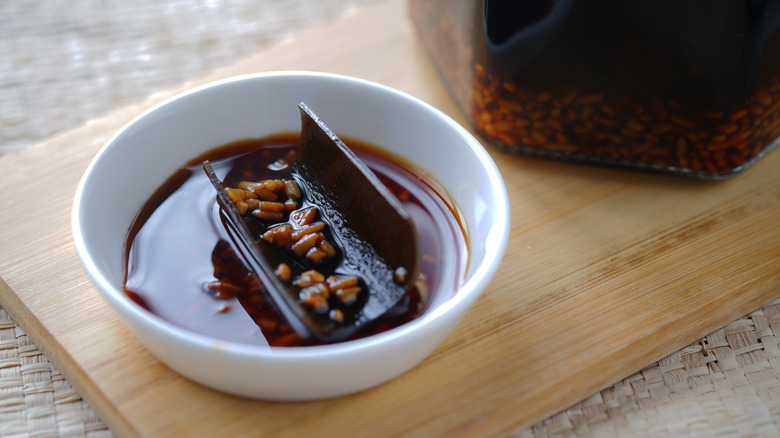A small bowl of mentsuyu on wooden board