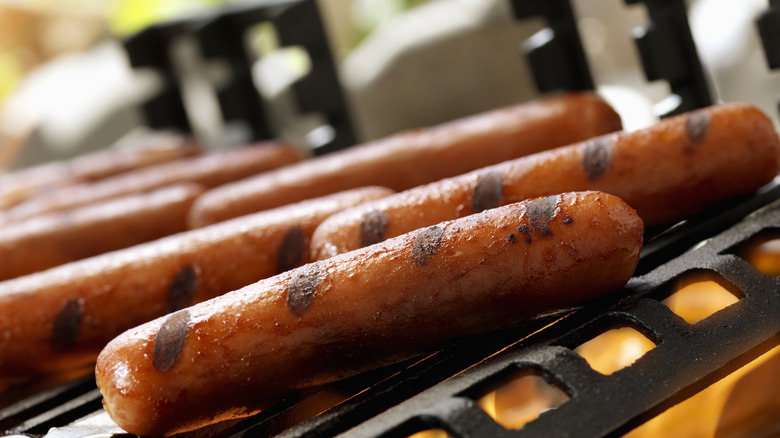 closeup of hot dogs on a grill