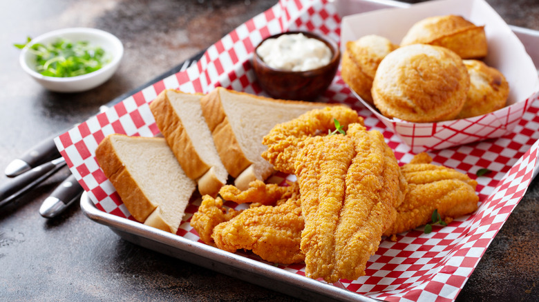 cornmeal-crusted catfish plate with bread and rolls