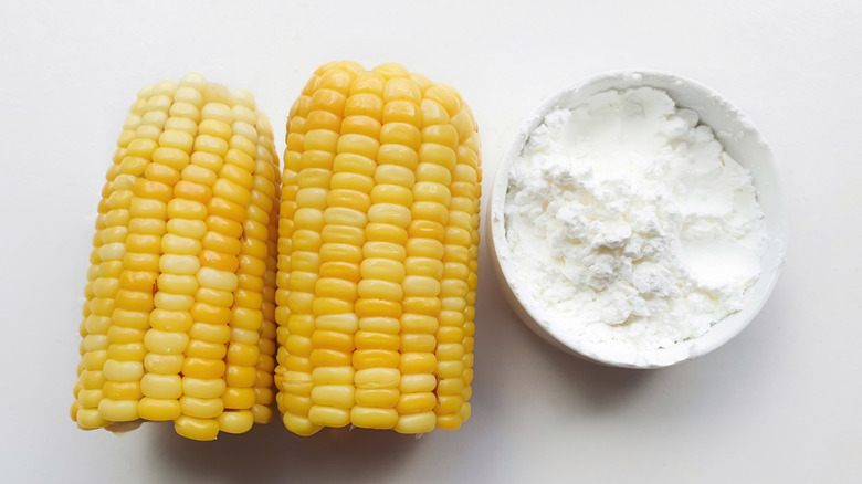 Corn cobs next to bowl of cornstarch