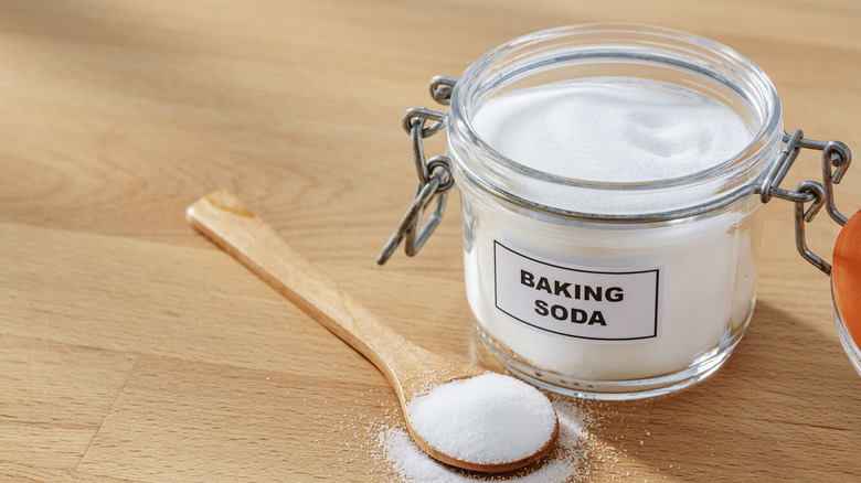 jar of baking soda with wood spoon