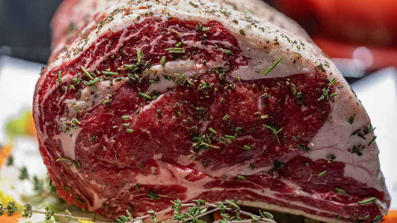 A seasoned raw prime rib roast