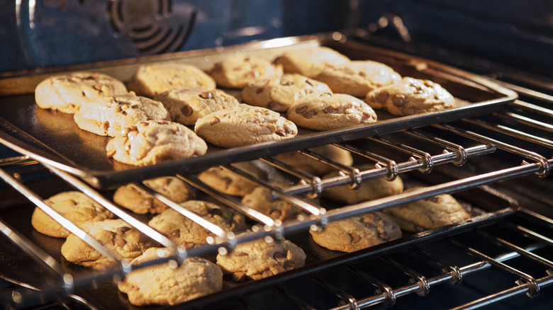 cookies baking on a tray in the oven