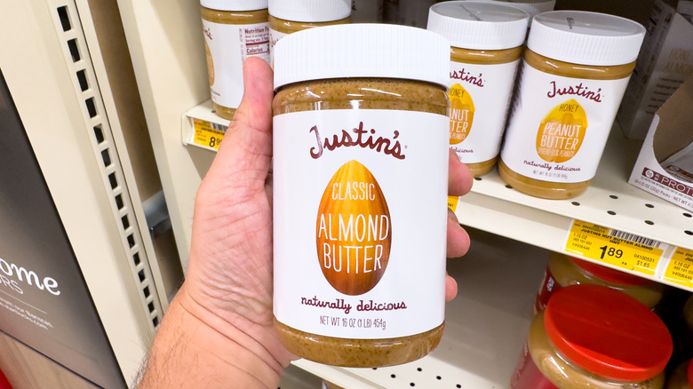 Jar of almond butter with sliced green apples