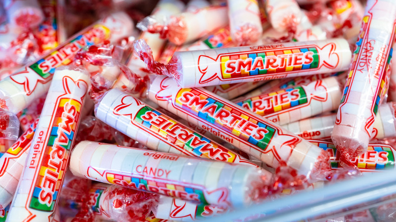 A close up of a pile of pastel-colored Smarties candies