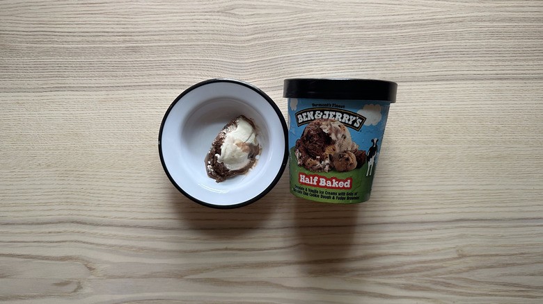 A bowl and pint container of Ben & Jerry's Half Baked flavor ice cream