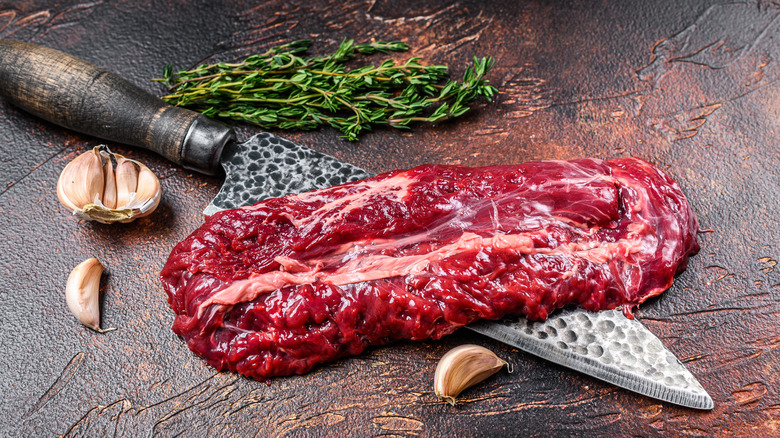 hangar steak on knife with garlic