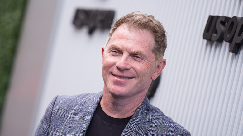 Bobby Flay smiling at an outdoor event