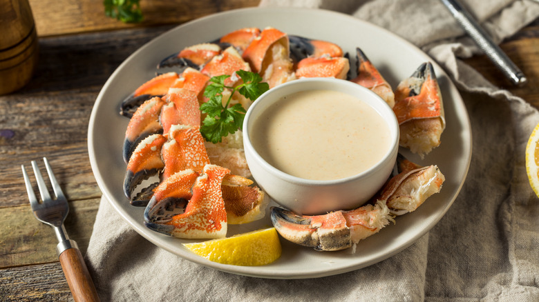 Stone crab claws around a dipping sauce