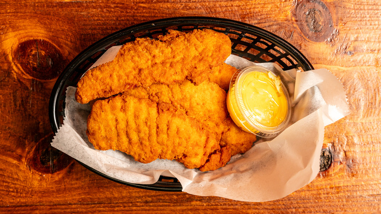 Chicken tenders in a basket at a restaurant