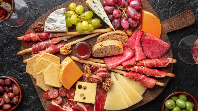 a classic charcuterie baord on a black texstured surface