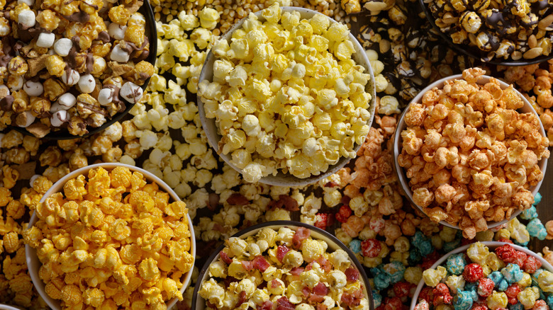different flavors of popcorn spilling out of bowls