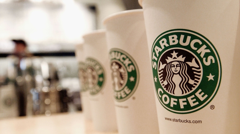 Cups of Starbucks coffee all lined up