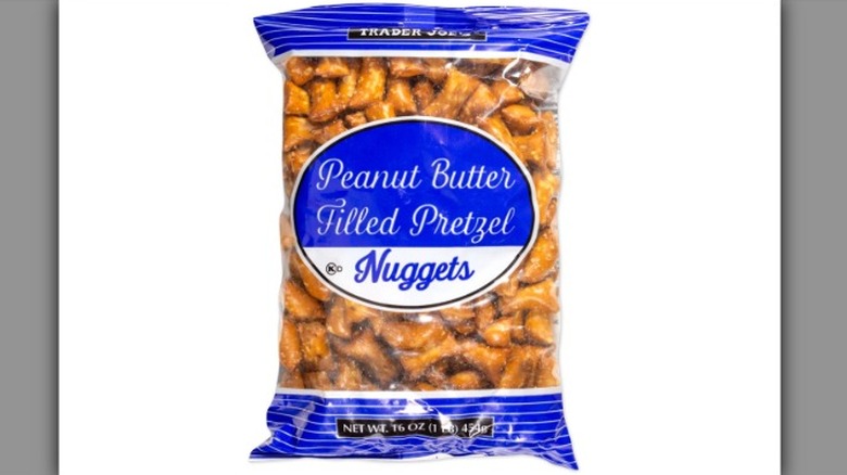 A bag of Trader Joe's Peanut Butter Filled Pretzel Nuggets is pictured on a white background.