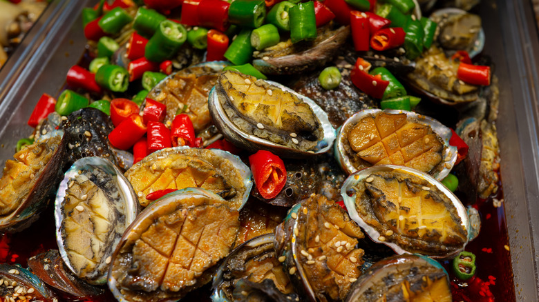 Steamed abalone served with roasted red and green chiles in a savory sauce