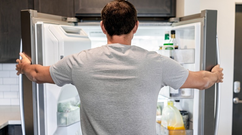 Man looking into his fridge
