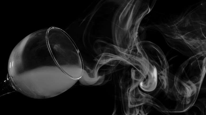 cocktail glass with smoke coming out of it