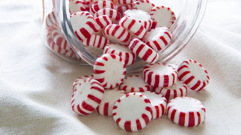 Peppermint candies spilling from a jar