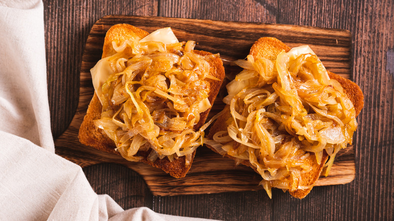 Close-up of toast topped with caramelized onions and cheese