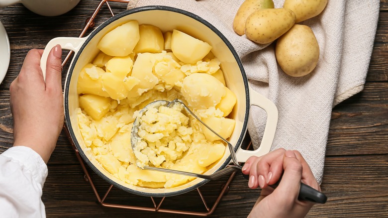 mashing potatoes by hand