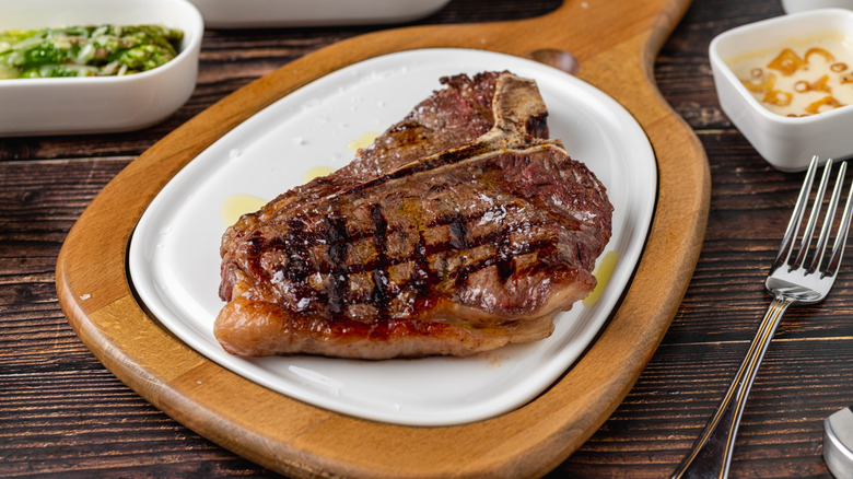 Close-up of a T-bone steak on a wooden table