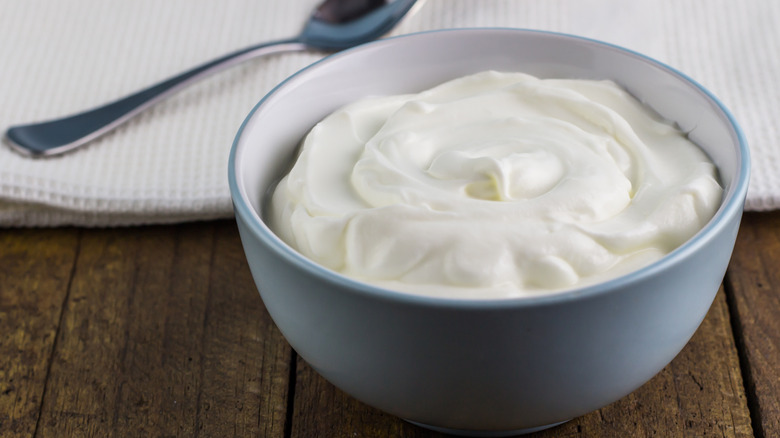 Grey bowl of Greek yogurt with spoon