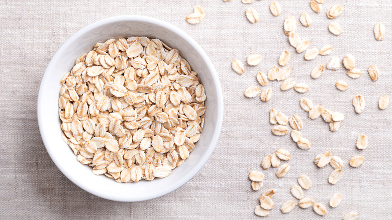 White bowl of raw oatmeal