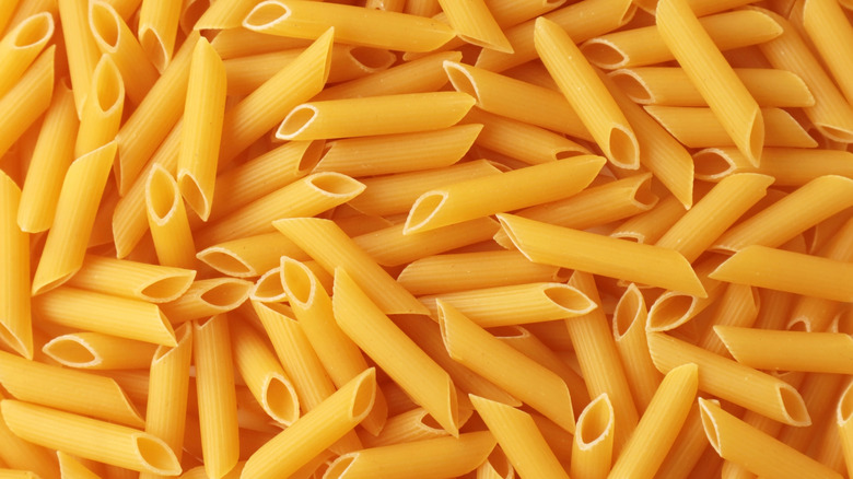 Uncooked penne pasta background