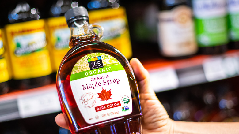 customer holding maple syrup jar