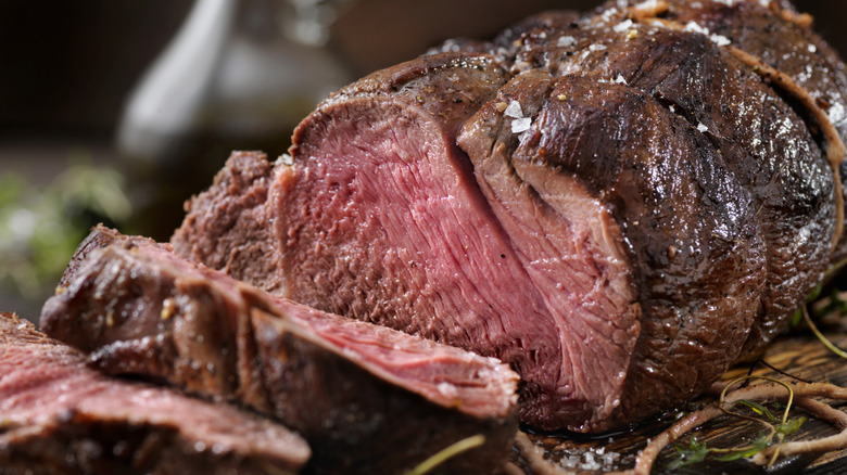 Closeup view of juicy sliced prime rib on a cutting board